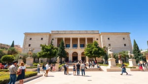 Visitors exploring the artistic facade of the Jerusalem Art Museum with sculptures and gardens.